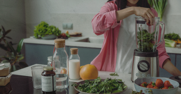 Woman preparing a healthy meal, illustrating the question of whether beef organ supplements are needed alongside a probiotic